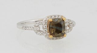 Lady's 18K White Gold Dinner Ring, with a 1.15 carat cushion cut alexandrite atop a border of tiny round diamonds, flanked by pierced diamond mounted 