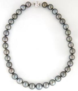 Graduated Strand of 35 Dark Gray Cultured Tahitian Pearls, ranging from 11-13 mm, with a 14k white gold ball clasp, L.- 17 1/2 in., with appraisal.