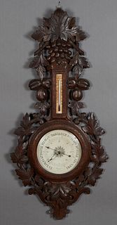 French Black Forest Style Carved Oak Barometer, 19th c., the highly carved grape and nut pierced top over an alcohol thermometer and a barometer marke