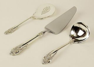 Lot of 3 Wallace Grande Baroque sterling silver serving pieces. This lot includes: tomato server; ladle; cake/pie server (hollow handle, stainless imp