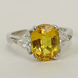 Lady's 4.50 Carat Oval Cut Yellow Sapphire, .80 Carat Diamond and Platinum Ring.
