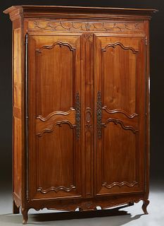 French Provincial Carved Cherry Louis XV Style Armoire, early 19th c., the stepped canted corner crown over double two panel doors with long iron fich