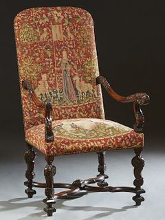 French Renaisance Style Carved Walnut Fauteuil a la Reine, late 19th c., the arched canted back to floral carved scrolled arms, on a cushioned seat on