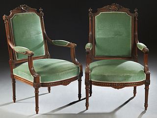 Pair of French Louis XVI Style Carved Walnut Fauteuils, 19th c., the arched crest rail carved with agrarian motifs on one and floral motifs on the oth
