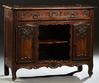 Unusual French Provincial Carved Oak Louis XV Style Carved Oak Sideboard, 19th c., the stepped sloping edge lifting top above a fall front writing sur