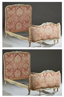 Pair of French Louis XV Style Polychromed Carved Beech Beds, 20th c., the serpentine upholstered headboards to polychromed wood rails and curved uphol