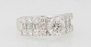 Lady's Platinum Dinner Ring, with a central round 1.54 carat diamond flanked by shoulders with a band of baguette diamonds, flanked by edge rows of ro