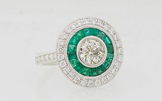 Lady's Platinum Dinner Ring, with a central .71 carat round diamond within a border of princess cut emeralds and an outer border of small round diamon
