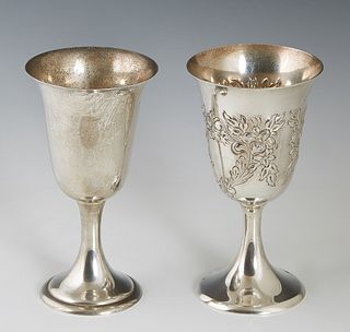 Two Sterling Goblets, 20th c., one hand chased by Frank Whiting Co, with repousse decoration, H.- 6 3/4 in., Dia.- 3 5/8 in., Wt.- 6.25 Troy Oz.; toge