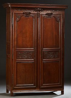 French Provincial Louis XV Style Carved Oak Armoire, 19th c., the stepped rounded corner crown over double three panel doors with long iron escutcheon