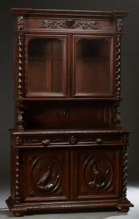 French Provincial Henri II Style Carved Oak Sideboard, c. 1880, the stepped breakfront crown over two setback glazed doors flanked by rope twist colum