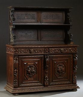 Continental Carved Oak Jacobean Style Sideboard, c. 1880, the sloping edge medallion carved top over two frieze drawers with animal head pulls flanked