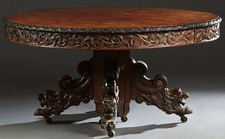 French Carved Oak Renaissance Style Dining Table, c. 1880, the oval top with a sloping medallion carved edge, on a central hexagonal support mounted w