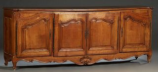 French Provincial Carved Cherry Louis XV Style Sideboard, 19th c., the stepped ogee edge cookie corner top over two central fielded panel cupboard doo