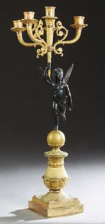 French Gilt and Patinated Bronze Figural Five Light Candelabra, 19th c., with four cornucopia arms around a central torch form candleholder, upheld by