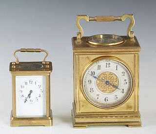 Two French Gilt Bronze Carriage Clocks, c. 1910, one with a beveled glass front and sides; the second with a beveled glass front and a top enclosing a