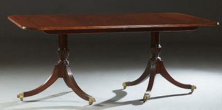 Georgian Style Inlaid Carved Mahogany Double Pedestal Dining Table, 20th c., the banded inlaid reeded edge rounded corner top, on urn form supports to
