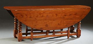 French Louis XIII Style Carved Cherry Drop Leaf Table, early 20th c., the oval top on turned and square legs, joined by rectangular stretchers, H.- 29