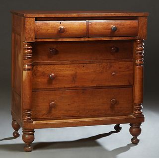 American Classical Carved Mahogany Chest, 19th c., the rectangular top over two convex frieze drawer above three setback drawers, flanked by turned co
