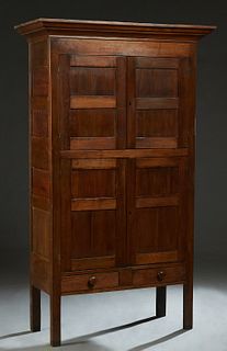 Louisiana Carved Walnut Pie Safe, late 19th c., the stepped ogee crown over double cupboard doors above larger cupboard doors over two frieze drawers,