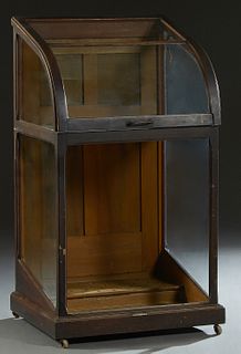 American Carved Mahogany Cane Display Case, 19th c., the slanted top with a crest curved front panel, above a lower glass panel, now lacking, the inte