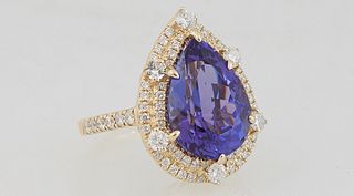 Lady's 14K White Gold Dinner Ring, with an 8.23 carat pear shaped tanzanite atop a conforming double concentric row of round diamonds, the shoulders o