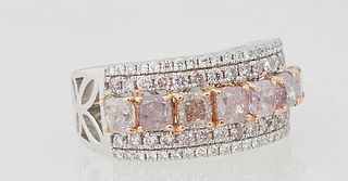 Lady's 18K White Gold Dinner Ring, with a central row of six pink princess cut diamonds within double edge borders of tiny white diamonds, the shoulde