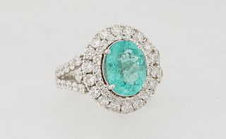 Lady's 14K White Gold Dinner Ring, with a 2.72 carat paraiba tourmaline, atop a double concentric graduated border of round diamonds, the split should