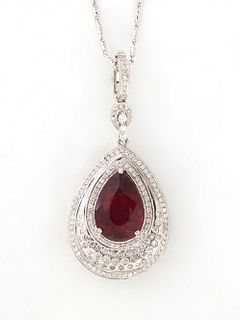 14K White Gold Pendant Necklace, with a 6.37 carat pear shaped rubelite atop four concentric graduated rows of small round diamonds, with a diamond mo