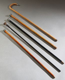 Group of Five Silver Mounted Walking Sticks, early 20th c., consisting of a tapered cylindrical example with a hammered sterling handle; a tapered map
