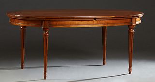 French Louis XVI Style Carved Cherry Dining Table, 20th c., the oval top over a wide skirt, on turned tapered reeded legs, with two semi circular leav