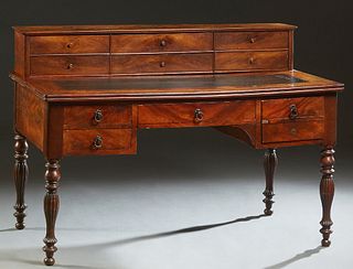 French Provincial Louis Philippe Carved Mahogany Desk, 19th c., with a rear superstructure with eight fitted drawers, on a base with an inset leather 