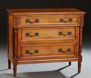 French Louis XVI Style Carved Cherry Commode, 20th c., the stepped top over a frieze drawer and two setback deep drawers, flanked by turned reeded pil