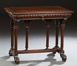 French Provincial Henri II Style Carved Oak Writing Table, the rounded edge top over a frieze drawer, on reeded trestle bases, joined by a stretcher w