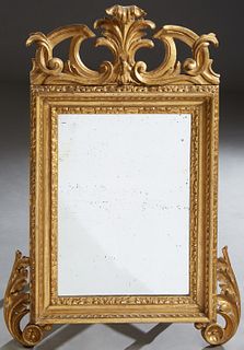 English Gilt and Gesso Overmantle Mirror, 19th c., with an arched feather top flanked by pierced scrolled panels, over a relief frame with two bottom 