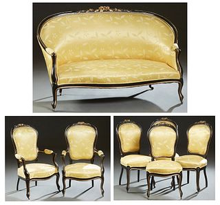 French Louis XV Style Ebonized Beech and Parcel Gilt Parlor Suite, c. 1870, consisting of a settee, two fauteuils, and four side chairs, the arched ba