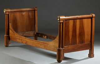 French Empire Ormolu Mounted Carved Walnut Lit du Coin, 19th c., the sleigh ends with cylindrical tops with end bronze mounts, on tapered cylindrical 