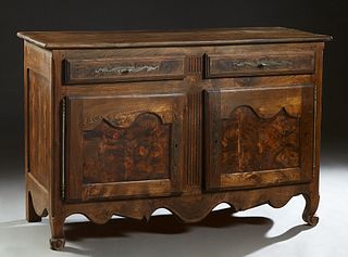 French Provincial Carved Elm Louis XV Style Sideboard, 19th c., the rounded edge four board top over two frieze drawers with long iron escutcheons, ab