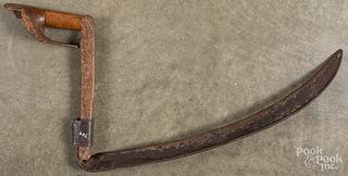 Unusual iron scythe with carved handle