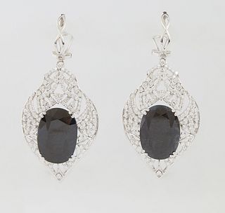 Pair of 14K White Gold Pendant Earrings, with oval blue 16.27 carat sapphires centering an elaborate pierced diamond mounted leaf form drop, total sap