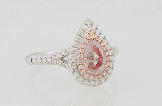 Lady's 18K White Gold Dinner Ring, with a pear shaped .62 carat pink diamond atop a conforming border of round diamonds, the split shoulders of the ba