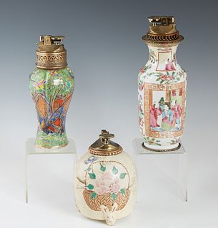Group of Three Chinese Porcelain Butane Table Lighters, 20th c., of baluster form, one famille rose; one ribbed with landscape decoration, and the thi