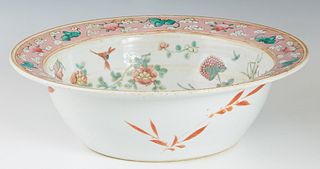 Chinese Famille Rose Porcelain Bowl, 19th c., the flat pink rim with cloud and fruit decoration over a sloping interior with floral and insect decorat