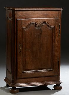 French Provincial Carved Oak Louis XIV Style Confiturier, 19th c., the stepped canted corner top over a fielded panel cupboard door with iron fiche hi