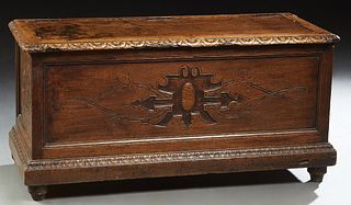 French Henri II Style Carved Oak Bedding Box, c. 1850, the carved edge top over three carved sides, on a plinth base, on turnip form feet, H.- 19 1/2 