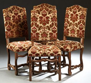 Set of Four Louis XIV Style Carved Beech Dining Chairs, 20th c., the arched canted cushioned backs to trapezoidal cushioned seats, on serpentine legs 