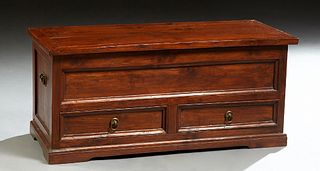 Carved Walnut Bedding Box, 20th c., the rectangular top lifting to open storage, above two lower drawers, on a plinth base, H.- 15 3/4 in., W.- 35 3/8