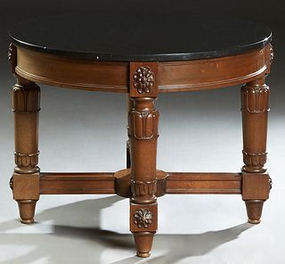 French Empire Style Carved Mahogany Marble Top Coffee Table, 20th c., the circular black marble over a wide skirt with relief floral carving, on rleif
