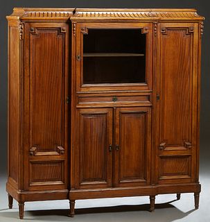 French Carved Oak Louis XVI Style Sideboard, early 20th c., the stepped sloping reeded breakfront top over a center glazed door above a frieze drawer 