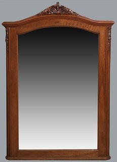 French Louis XVI Style Carved Mahogany Overmantle Mirror, early 20th c., the arched shell and floral carved stepped crown over an arched wide beveled 